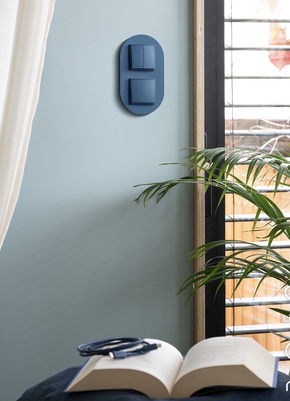 Slate blue oval two-gang switch on a bedroom wall